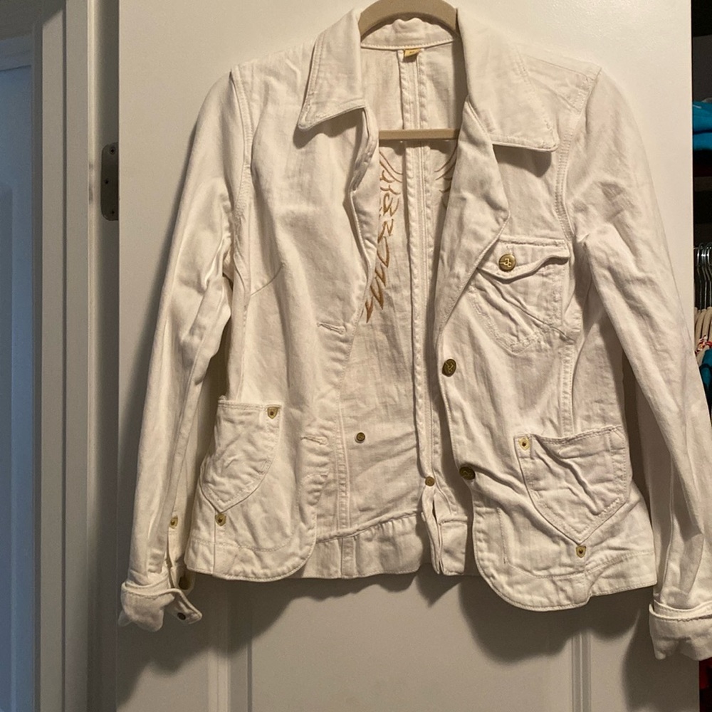 White denim jacket with gold wing emblem on back. Button enclosure. Size medium
